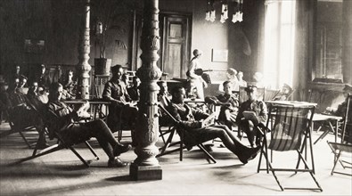 The British Empire Leave Club at Cologne. British Army officers relax in deckchairs inside the