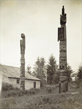 Tlingit totem poles, Alaska. Two Native American totem poles stand outside Chief Shakes Tribal