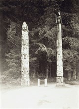 Totem poles in Sitka National Park. Two Native American totem poles mark the entrance to Lover's