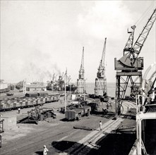 Mormugao docks. Dockside cranes and freight cars at Mormugao Port. Mormugao, Goa, India, circa 1937