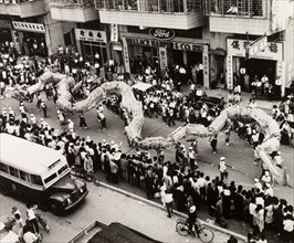 Dragon dance for the Tin Hau Festival. A Chinese dragon dance winds its way through crowds of