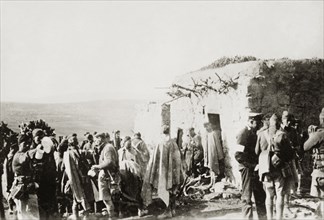 Troops at a village in Samaria. British and Arab soldiers and police gather outside a village