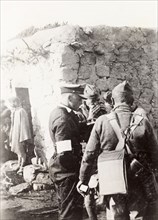 Police and army cooperation' in Samaria. British soldiers and police gather outside a village
