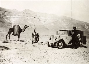 Signaller in the Palestinian desert. A British officer of the Royal Corps of Signals stops his car