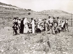 Searching a group of Arab villagers. British soldiers search a group of Palestinian Arab villagers