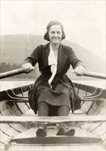 Beryl Phelps rows a boat. Portrait of Beryl Phelps rowing a boat off the shore at Eastbourne.