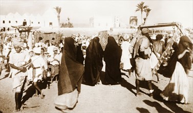 Muslim women at Sheikh Othman. Women wearing traditional Muslim burqas move amongst the crowds at a