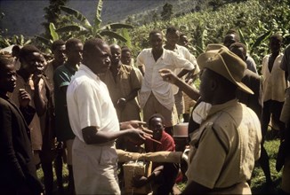 Recruiting porters at Budadiri. A Ugandan Forest Ranger negotiates for porters with a chief at