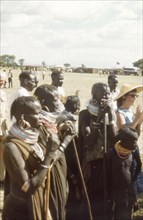 An intrigued audience for the Uganda Police Band'. A group of Pian women and children watch a