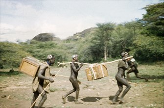 Suk porters hurry to leave camp. Suk (Pokot) porters working with a British forestry survey team