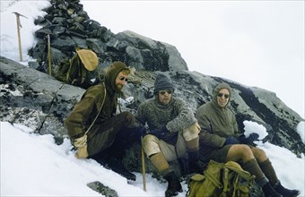 Mountaineers at the summit of Mount Speke. Three mountaineers rest at the summit of Mount Speke in