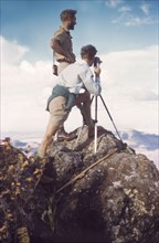 On the summit of Mount Napak. District Forestry Officer James Lang Brown (left) surveys Karamoja