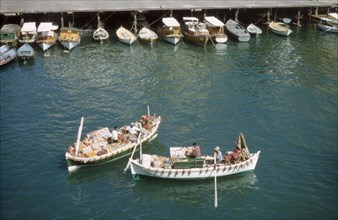 Bumboats at Port Said'. Two bumboats filled with trade wares float in the harbour at Port Said.