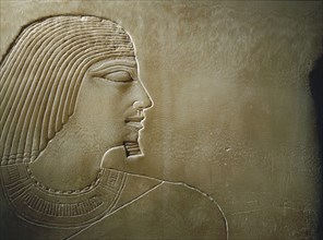 An alabaster panel decorated in sunk relief with a profile head and torso of Rawer