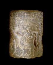 Early dynastic Sumerian alabaster cylinder seal, inscribed with a scene of a seated figure being handed a beaker by an attendant, and a nude hero, conventionally regarded as Gilgamesh, in conflict wit...