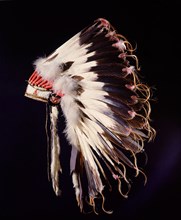 War bonnet of eagle tail feathers, each feather signifying a specific war honour