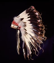 War bonnet of eagle tail feathers, each feather signifying a specific war honour