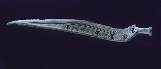 Knife with curved back and engraved design