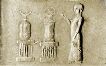 Seal depicting a bare headed priest before divine symbols of the goddess Ishtar (star) and the god Sin (moon crescent) set on altars