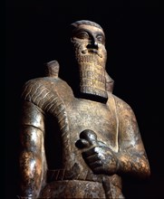 Statue of King Ashurnasirpal II holding the symbols of sovereignty