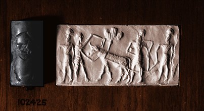 Cylinder seal of a man holding an ox which pulls a seed plough guided by two further bearded figures