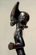 Wood figure of wearing headdress that is characteristic of Chokwe chiefs and also found on important masks