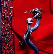 Ornament in the form of a dragon holding the pearl of wisdom