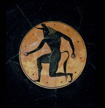 Attic, bilingual, eye cup with black figure interior depicting running minotaur and inscription reading the boy is beautiful