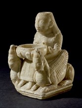 Hollowed out figure of a female goddess of oriental origin, possibly associated with Astarte, seated on a throne like chair, flanked by two winged sphinxes