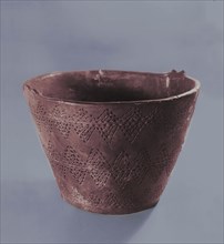 Bucket shaped vessel in stroke ornamented ware