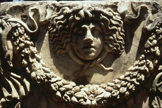 Relief of Medusa head encircled by snakes and garland from a stone sarcophagus