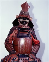 This suit of armour bears a Buddhist gold lacquer inscription on the breastplate