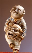 Porcelain netsuke of a lion dancer