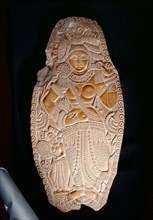 Carving of a goddes holding a lotus flower, An attendant at the left