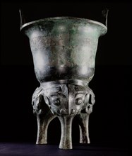 Archaic bronze vessel, Li Ding, with long tao tieh masks on the legs