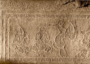 Brick from a tomb structure impressed with a desing depicting players of pan pipes and a dancer
