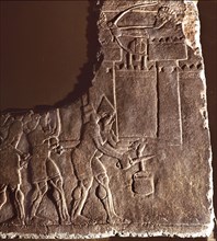 Fragment of a relief showing Assyrian soldiers cutting a well rope of a besieged city