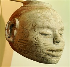 Pottery effigy head vessel with the forked  or winged eye motif