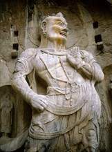 One of the guardian kings of Buddhism carved on the north wall of the Fengxian temple at theLongmen cave temple complex