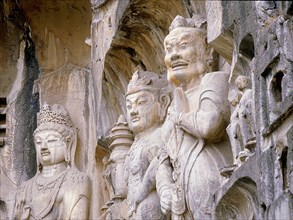 The Guardian kings of Buddhism carved on the north wall of the Fengxian temple at the Longmen cave temple complex