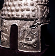 Detail of the design on a helmet, showing a warrior killing a ram
