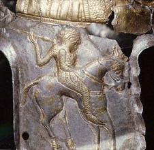 Detail of the design on a helmet, showing a horseman with a spear