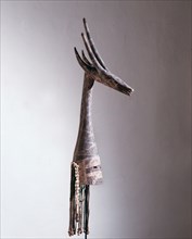 Although in the form of a gazelle these mask headdresses actually depict and are called by the name of a specific dead elder