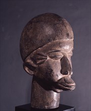 Lobi wooden head with characteristic scarification and lip plug