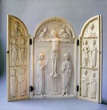 A triptych for private devotional use carved with the Crucifixion attended by the archangels Michael and Gabriel, the Virgin and St John