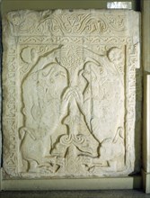 A slab carved in relief with a Tree of Life flanked by two lions