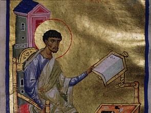 An illumination from a manuscript depicting St Luke writing at his desk