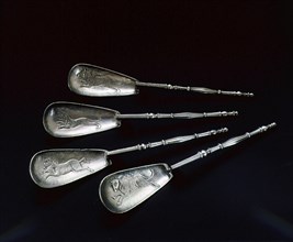 Four silver spoons with relief representations of animals in the bowls