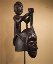 A helmet mask with male figure