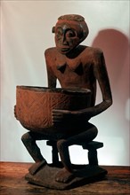 A seated female bowl figure, probably a royal prestige object